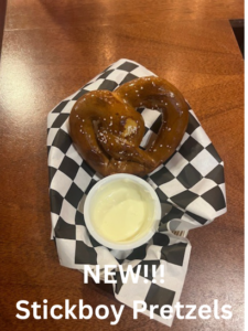 A basket of onion rings with a dipping sauce and 'NEW!!' text.
